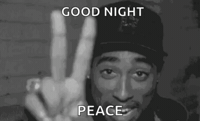 A Man In A Hat Is Giving A Peace Sign In A Black And White Photo . GIF