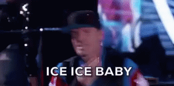 A Man In A Hat Is Holding A Balloon And Says `` Ice Ice Baby '' While Standing In A Car . GIF