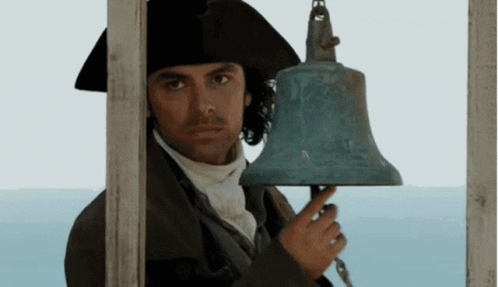 A Man In A Hat Is Holding A Bell GIF