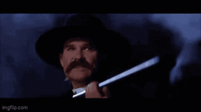 A Man In A Hat Is Holding A Gun And Saying Clouds Comin ' With Me . GIF