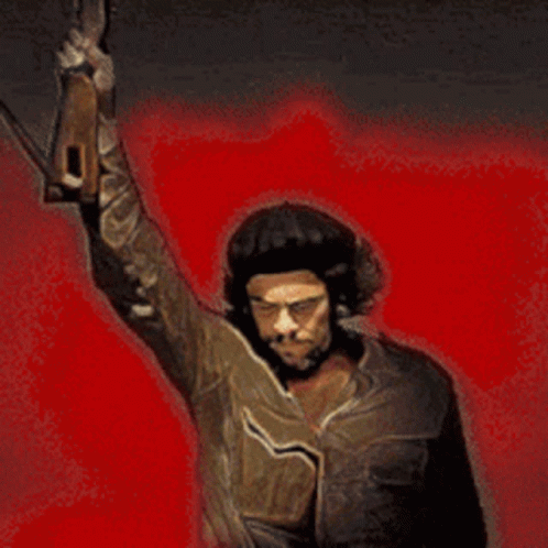 A Man In A Hat Is Holding A Gun Up In The Air GIF