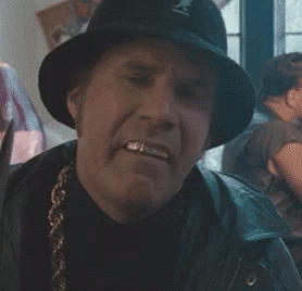 A Man In A Hat Is Holding A Knife In His Mouth GIF