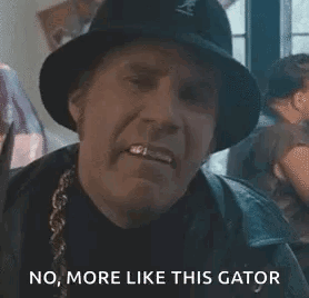 A Man In A Hat Is Holding A Pair Of Scissors In His Hand And Making A Face . GIF
