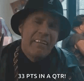 A Man In A Hat Is Holding A Pair Of Scissors In His Hand . GIF