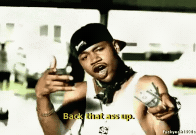 A Man In A Hat Is Pointing At The Camera And Says Back That Ass Up . GIF