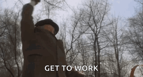 A Man In A Hat Is Raising His Fist In The Air . GIF
