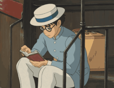 A Man In A Hat Is Reading A Book While Sitting On A Railing GIF
