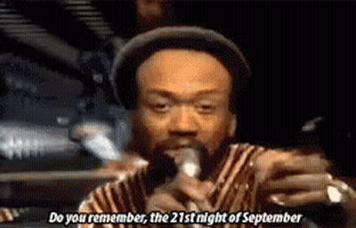 A Man In A Hat Is Singing Into A Microphone And Saying Do You Remember The 21St Night Of September . GIF