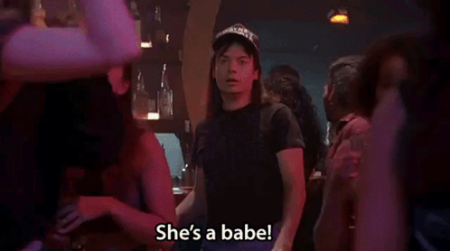 A Man In A Hat Is Standing In A Crowd And Says She 'S A Babe . GIF