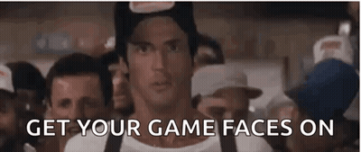 A Man In A Hat Is Standing In Front Of A Crowd Of People With The Words `` Get Your Game Faces On '' . GIF