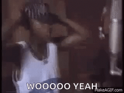 A Man In A Hat Is Standing In Front Of A Microphone And Says Woooo Yeah . GIF