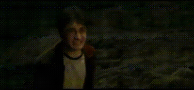 A Man In A Hat Is Standing In The Dark And Saying `` Coward '' . GIF