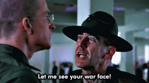 A Man In A Hat Is Talking To Another Man With The Words Let Me See Your War Face GIF
