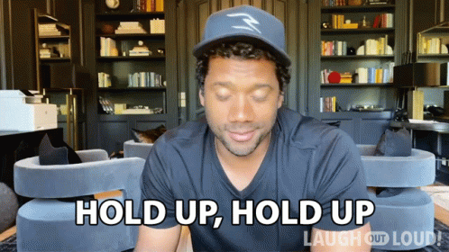 A Man In A Hat Says Hold Up Hold Up GIF