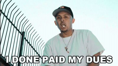 A Man In A Hat Says " I Done Paid My Dues " In Front Of A Fence GIF