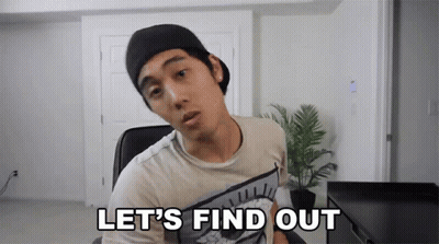 A Man In A Hat Says Let 'S Find Out In Front Of A Plant GIF