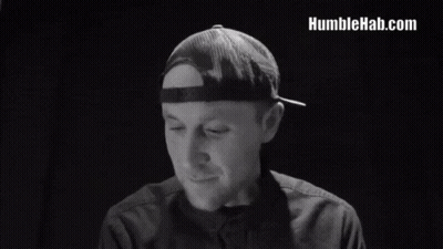 A Man In A Hat Says We Are Human After All In A Black And White Photo GIF