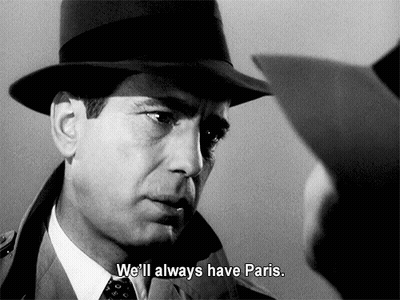 A Man In A Hat Says " We 'Ll Always Have Paris " In A Black And White Photo GIF