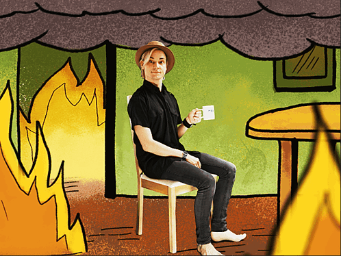 A Man In A Hat Sits In A Chair Holding A Cup Of Coffee GIF