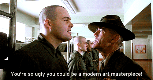 A Man In A Hat Talks To Another Man In A Military Uniform GIF