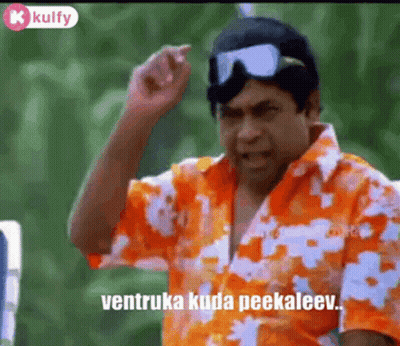 A Man In A Hawaiian Shirt And Goggles Is Making A Funny Face . GIF