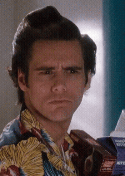 A Man In A Hawaiian Shirt Is Holding A Box That Says Kitty GIF