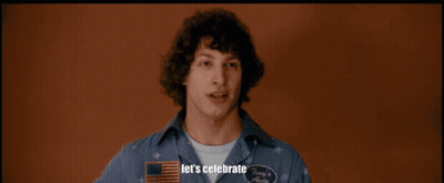 A Man In A Hawaiian Shirt Is Holding A Piece Of Bubble Wrap In A Room With Other Men GIF
