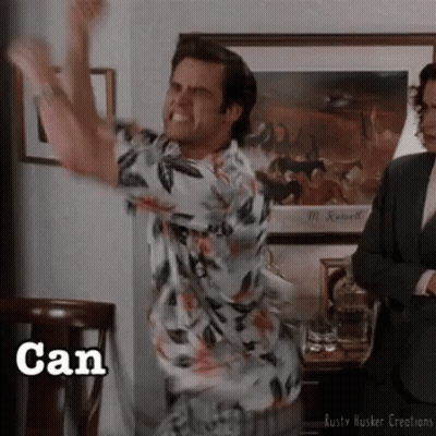 A Man In A Hawaiian Shirt Is Jumping In The Air With The Word Can Written Below Him GIF