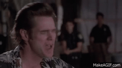 A Man In A Hawaiian Shirt Is Making A Funny Face In Front Of A Group Of Police Officers . GIF