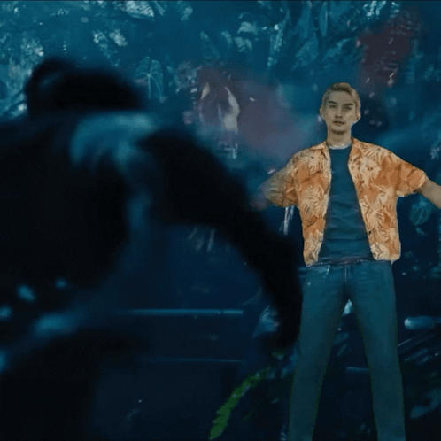 A Man In A Hawaiian Shirt Is Standing In The Dark GIF