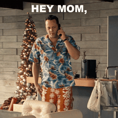 A Man In A Hawaiian Shirt Is Talking On A Cell Phone And The Words Hey Mom Are Above Him GIF