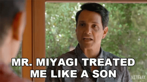 A Man In A Hawaiian Shirt Is Talking To Another Man And Saying Mr. Miyagi Treated Me Like A Son . GIF