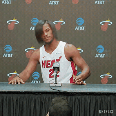 A Man In A Heat Jersey Is Sitting At A Table GIF