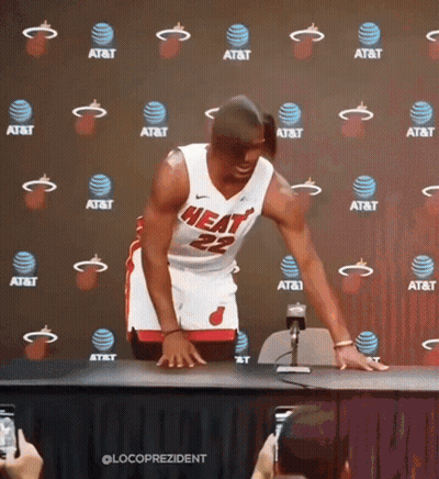A Man In A Heat Jersey Stands In Front Of An At & T Backdrop GIF