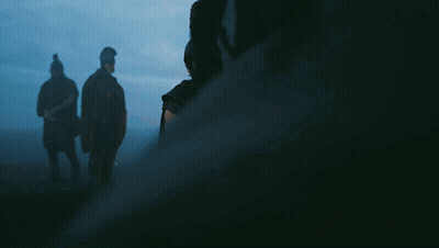 A Man In A Helmet Holds A Sword In His Hand GIF