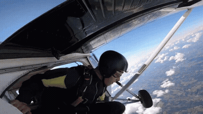 A Man In A Helmet Is Flying Through The Air GIF