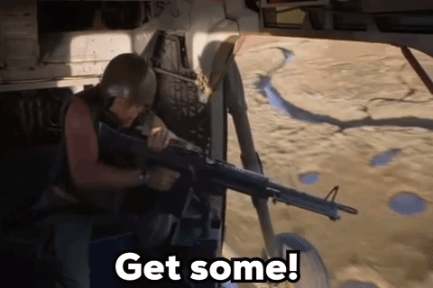 A Man In A Helmet Is Holding A Gun And Says Get Some GIF