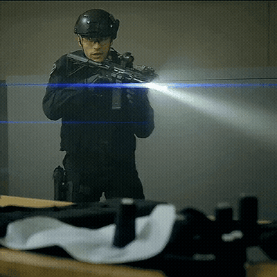 A Man In A Helmet Is Holding A Gun GIF