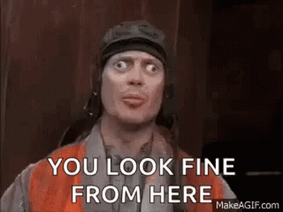 A Man In A Helmet Is Making A Funny Face And Says `` You Look Fine From Here '' . GIF