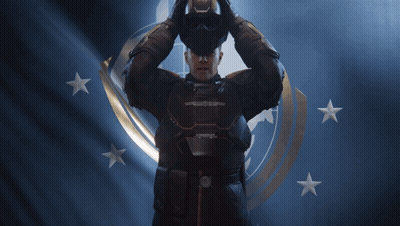 A Man In A Helmet Is Standing In Front Of A Flag With Stars GIF
