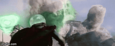 A Man In A Helmet Is Standing In Front Of A Green Explosion In A Movie . GIF