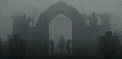 A Man In A Helmet Is Standing Next To Another Man In A Black Suit . GIF