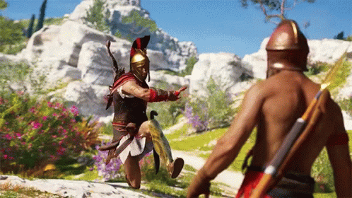 A Man In A Helmet Is Standing Next To Another Man With A Spear GIF