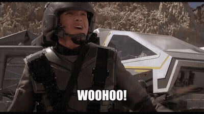 A Man In A Helmet Says Woohoo In Front Of A Spaceship GIF