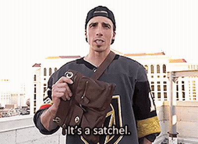 A Man In A Hockey Jersey Is Holding A Bag And Says It 'S A Satchel GIF