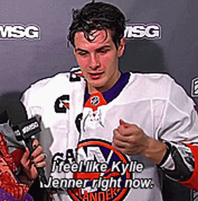 A Man In A Hockey Jersey Is Talking Into A Microphone And Says " Feel Like Kyle Jenner Right Now " GIF