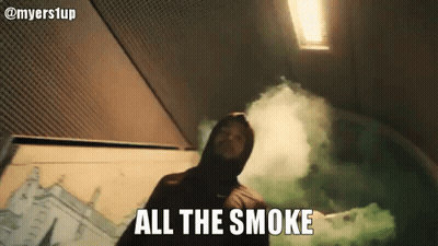 A Man In A Hood Is Holding A Green Smoke Bomb And Says All The Smoke . GIF