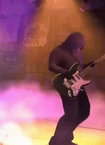 A Man In A Hood Is Playing An Electric Guitar GIF