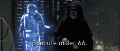 A Man In A Hood Says Execute Order 66 In Front Of A Hologram Of A Storm Trooper GIF