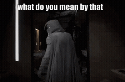 A Man In A Hooded Cape Is Standing In Front Of A Mirror With The Words `` What Do You Mean By That '' . GIF